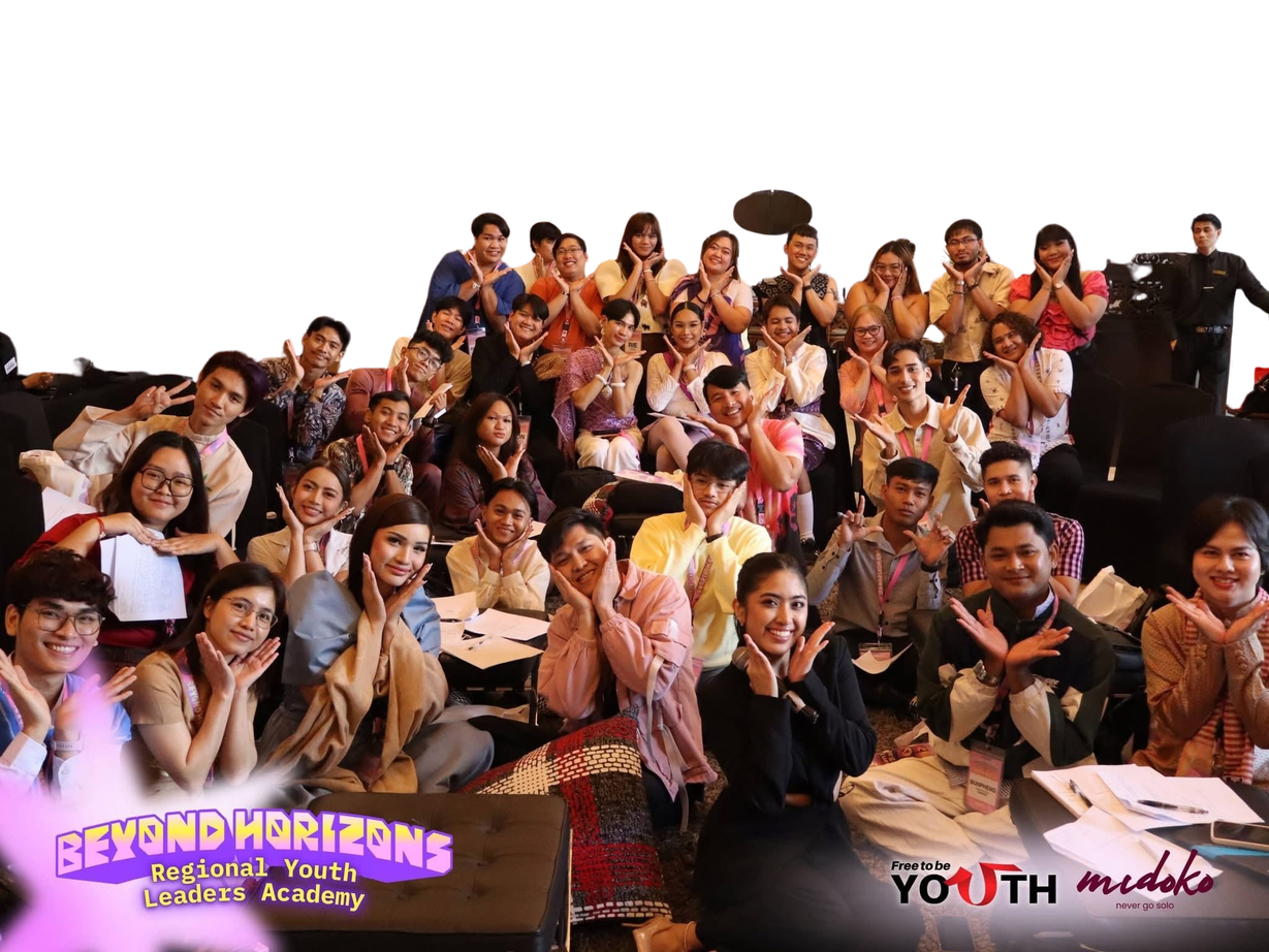 A large, smiling group at a community youth event